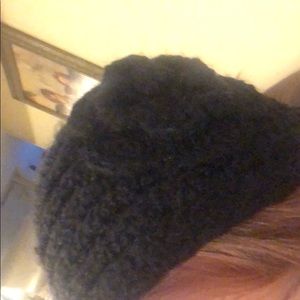 Black knit ear warmers with flower detail.